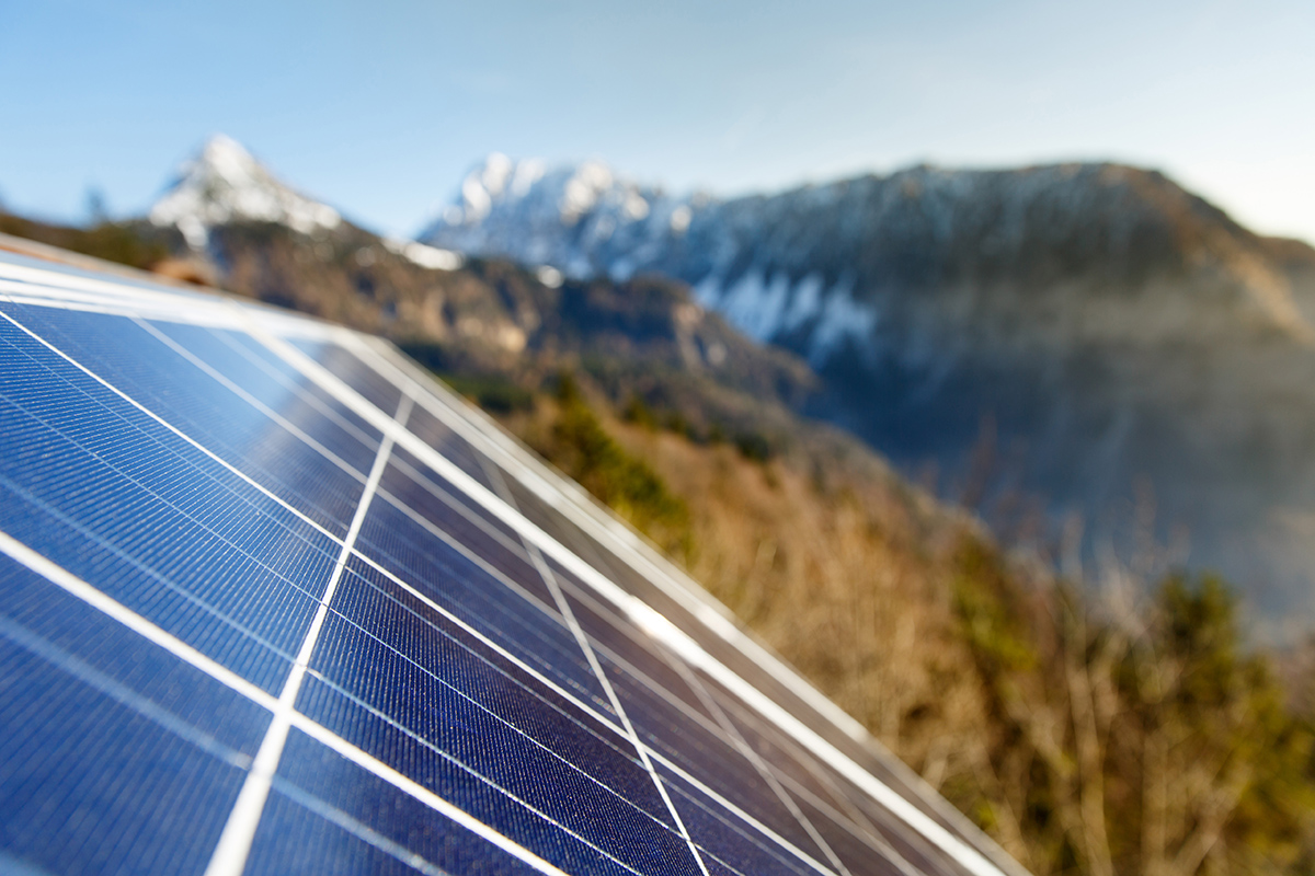 Closeup of photovoltaic solar panels in mountainous natural area, gathering sunlight. Sustainable resources, environmental conservation, alternative power source and generation, green energy concept.